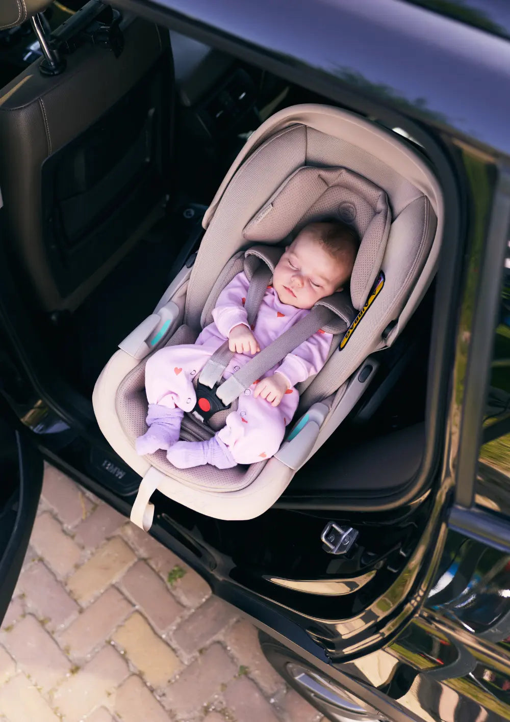 Baby schläft in der Joolz x Maxi-Cosi Babyschale 'Pebble Slide Pro' Sandy Taupe m Auto